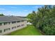 Exterior side view of the apartment showing a well-maintained lawn next to the lake at 2893 S Osceola Ave # E6, Orlando, FL 32806