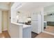 Modern kitchen area featuring a breakfast bar, wood floors and white cabinets at 2893 S Osceola Ave # E6, Orlando, FL 32806
