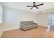 Living room featuring hardwood floors, a modern ceiling fan, and a comfortable gray sofa at 2893 S Osceola Ave # E6, Orlando, FL 32806