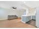 Bright living room with a gray sofa open to the kitchen with stylish pendant lighting and light gray cabinets at 2893 S Osceola Ave # E6, Orlando, FL 32806