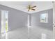 Bright bedroom with tiled floors, neutral paint, and large windows for ample natural light at 300 Florida Pkwy, Kissimmee, FL 34743