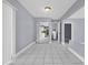 Hallway with tiled floors, closet, and leading to an adjacent room at 300 Florida Pkwy, Kissimmee, FL 34743