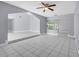 Open-concept living room with tiled floors, neutral walls, and seamless transition to adjacent spaces at 300 Florida Pkwy, Kissimmee, FL 34743