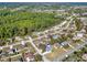A beautiful community featuring mature trees, single Gathering homes, and green spaces from an aerial view at 3235 Utah Dr, Deltona, FL 32738
