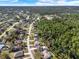 Expansive view showcasing a residential community bordering a lush forest, with tree-lined streets and single-Gathering homes at 3235 Utah Dr, Deltona, FL 32738