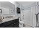 This bathroom features granite countertops, dark cabinetry, and a shower-tub combo for a modern touch at 3235 Utah Dr, Deltona, FL 32738