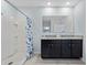 Bathroom featuring a spacious shower, double vanity with granite countertop, and modern fixtures at 3235 Utah Dr, Deltona, FL 32738
