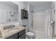 Bathroom with a single sink vanity, granite counters, shower over tub, vanity cabinet, and neutral walls and flooring at 3235 Utah Dr, Deltona, FL 32738