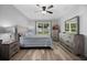 Bedroom with wood-look floors, ceiling fan and a window providing natural light at 3235 Utah Dr, Deltona, FL 32738