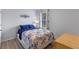 Comfortable bedroom featuring a bed with blue bedding, stylish curtains, and a side table at 3235 Utah Dr, Deltona, FL 32738