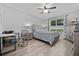 Bright bedroom featuring a comfortable bed, stylish nightstands, and a desk and chair, with ample space to work at 3235 Utah Dr, Deltona, FL 32738