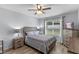 Serene bedroom with a large window, ceiling fan, and neutral decor at 3235 Utah Dr, Deltona, FL 32738