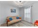 Guest bedroom with a futon, round light fixture, simple window dressings, and neutral walls and flooring at 3235 Utah Dr, Deltona, FL 32738