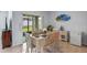 Bright dining room with a table for six, sliding glass doors to the backyard at 3235 Utah Dr, Deltona, FL 32738