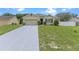 Charming single-story home with a well-manicured lawn, gray driveway, and a two-car garage at 3235 Utah Dr, Deltona, FL 32738