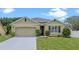 Charming single-story home featuring a well-maintained lawn and a two-car garage at 3235 Utah Dr, Deltona, FL 32738