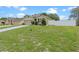 Charming one-story home featuring manicured landscaping, an attached garage, and a white fence at 3235 Utah Dr, Deltona, FL 32738