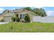 Charming one-story home featuring manicured landscaping, an attached garage, and a white fence at 3235 Utah Dr, Deltona, FL 32738