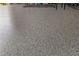 Close-up of a garage floor with epoxy finish, showcasing its durability and easy-to-clean surface at 3235 Utah Dr, Deltona, FL 32738