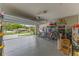 A well-organized garage with an epoxy floor and ample storage space and an open door at 3235 Utah Dr, Deltona, FL 32738