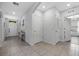 Hallway with neutral tile flooring, entry door, storage closet, and view to adjacent room at 3235 Utah Dr, Deltona, FL 32738