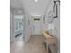 Inviting entryway with neutral-toned walls, decorative accents, and a glimpse into the adjacent bedroom at 3235 Utah Dr, Deltona, FL 32738