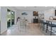 Bright kitchen features a granite island, stainless steel appliances, a dining area, and sliding doors to the backyard at 3235 Utah Dr, Deltona, FL 32738