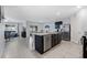 Modern kitchen with central island, stainless steel appliances, and open layout into the living area at 3235 Utah Dr, Deltona, FL 32738
