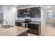 Open-concept kitchen with granite countertops, stainless steel appliances, and dark cabinetry at 3235 Utah Dr, Deltona, FL 32738