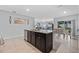 Bright kitchen features a granite island, modern stainless steel appliances, and open access to living and dining areas at 3235 Utah Dr, Deltona, FL 32738