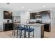 Well-appointed kitchen features granite countertops, stainless steel appliances, an island with bar seating and tiled floors at 3235 Utah Dr, Deltona, FL 32738