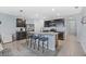 Spacious kitchen featuring granite countertops, stainless steel appliances, an island with bar seating, and tiled floors at 3235 Utah Dr, Deltona, FL 32738
