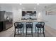 Modern kitchen with a granite island, stainless steel refrigerator, and bar stool seating at 3235 Utah Dr, Deltona, FL 32738