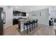 Well-appointed kitchen features granite countertops, stainless steel appliances, an island with bar seating and tiled floors at 3235 Utah Dr, Deltona, FL 32738