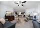 Spacious living room with comfortable seating, an open layout, modern décor, tile floors, and a ceiling fan at 3235 Utah Dr, Deltona, FL 32738