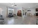 Open-concept living room with comfortable seating, tile floors, a dining area, and lots of natural light at 3235 Utah Dr, Deltona, FL 32738