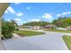 A house on a street with a green lawn and landscaping is displayed from the driveway at 3235 Utah Dr, Deltona, FL 32738