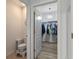Bright walk-in closet featuring wood floors, ample storage, and a stylish chandelier at 3235 Utah Dr, Deltona, FL 32738
