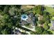 Overhead shot of a stately home with a pool, complemented by lush landscaping and neatly manicured lawns at 3428 Chaine Du Lac Blvd, Windermere, FL 34786