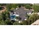 Overhead view of beautiful home with pool, surrounded by lush landscaping and colorful trees in a well-maintained neighborhood at 3428 Chaine Du Lac Blvd, Windermere, FL 34786
