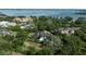 An aerial view of a waterfront estate with lush landscaping and a grand home at 3428 Chaine Du Lac Blvd, Windermere, FL 34786