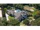 Magnificent home featuring a gray tile roof, backyard pool, and meticulously landscaped grounds at 3428 Chaine Du Lac Blvd, Windermere, FL 34786