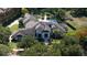A high-angle shot of a luxury home with a tile roof and resort-style backyard at 3428 Chaine Du Lac Blvd, Windermere, FL 34786