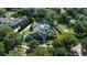 Luxury home with a pool amidst lush landscaping, complemented by picturesque neighborhood greenery and tree-lined streets at 3428 Chaine Du Lac Blvd, Windermere, FL 34786