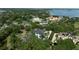 Expansive estate home with a private pool, lush landscaping, and stunning lake views at 3428 Chaine Du Lac Blvd, Windermere, FL 34786