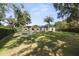 Expansive backyard featuring a manicured lawn and mature trees at 3428 Chaine Du Lac Blvd, Windermere, FL 34786