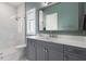 Well-lit bathroom showcasing a glass-enclosed shower, gray vanity, and modern fixtures, offering a serene retreat at 3428 Chaine Du Lac Blvd, Windermere, FL 34786