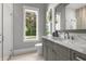 Stylish bathroom with a glass-enclosed shower, a large window offering natural light, and a modern vanity at 3428 Chaine Du Lac Blvd, Windermere, FL 34786