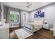 Comfortable bedroom featuring a ceiling fan, a large picture window, and a cozy rug at 3428 Chaine Du Lac Blvd, Windermere, FL 34786