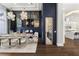 Elegant dining room featuring modern light fixture, adjacent wine cellar, and stylish decor at 3428 Chaine Du Lac Blvd, Windermere, FL 34786